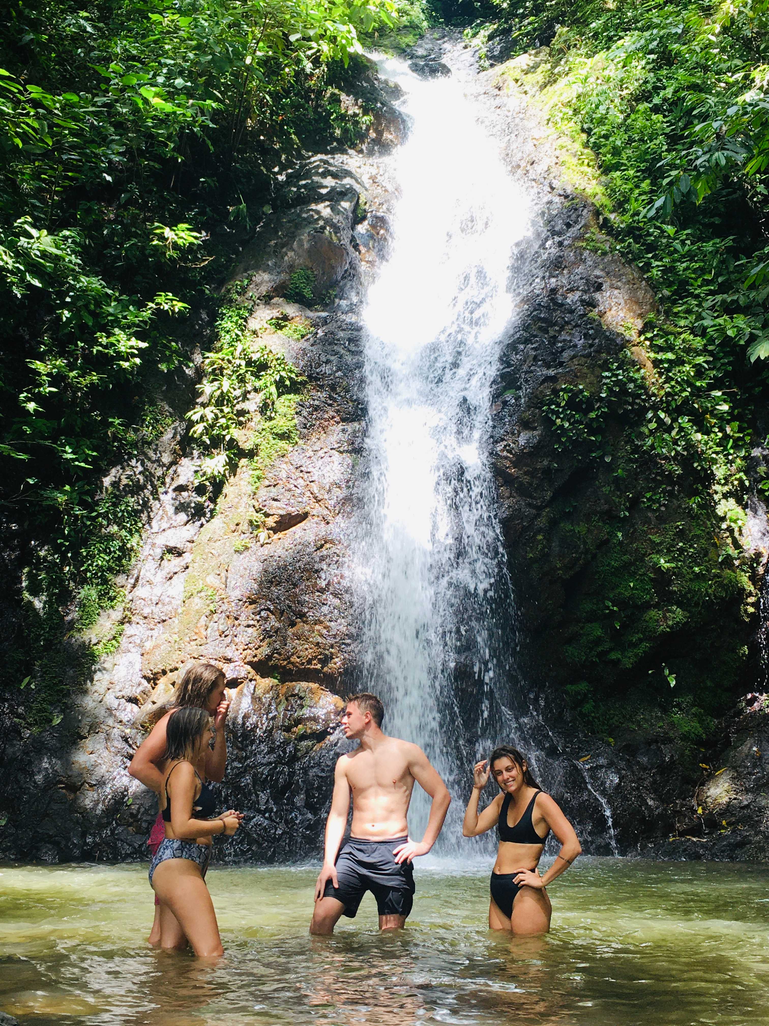 Standing under a waterfall in Costa Rica